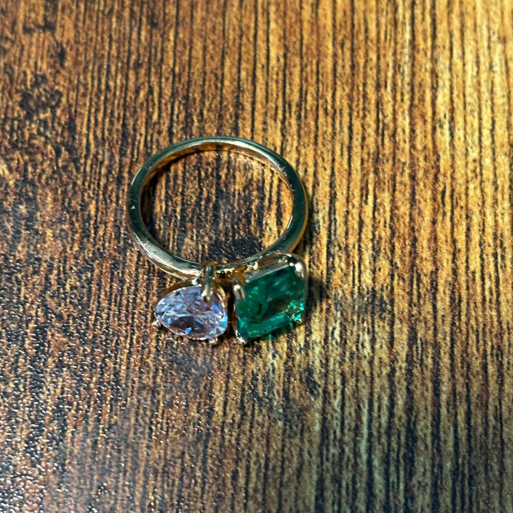 Gold band with green and clear cubic zirconia, square and pair cut stones